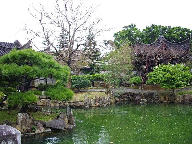 Un parc urbain luxuriant avec un lac rempli de koi.