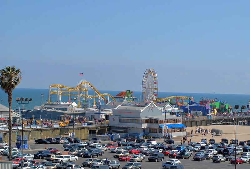 Parque de atracciones a orillas del mar con atracciones y comida